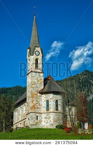 Mountains Over Gosau Village With Catholic Church Under Sunlight. Location: Resort Village Gosau Sal