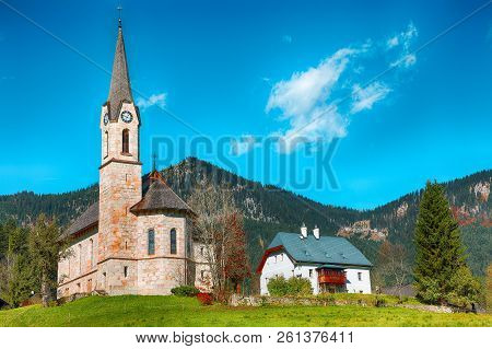 Mountains Over Gosau Village With Catholic Church Under Sunlight. Location: Resort Village Gosau Sal