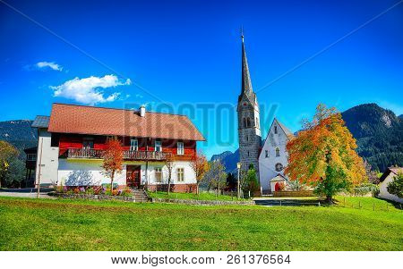 Mountains Over Gosau Village With Catholic Church Under Sunlight. Location: Resort Village Gosau Sal