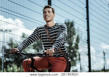 Attractive Enthusiastic Guy Relishing Ride On Bicycle