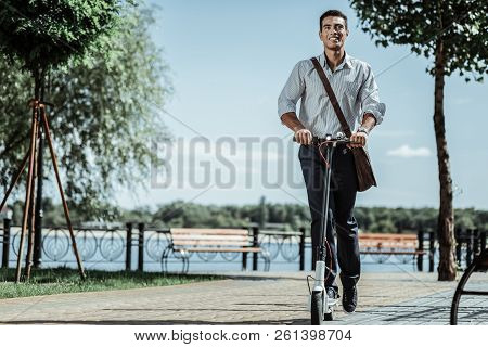 Attractive Positive Guy Testing New Electric Scooter