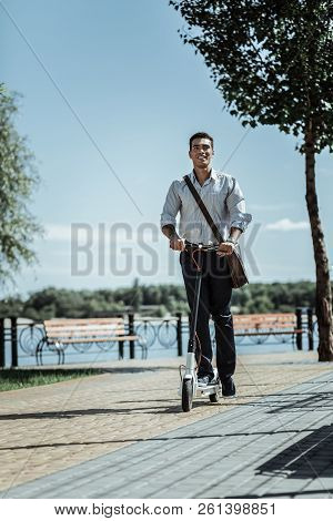 Happy Active Guy Changing Car To Electric Scooter