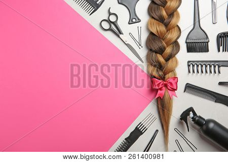Flat Lay Composition With Braid, Hairdresser's Tools And Space For Text On Color Background