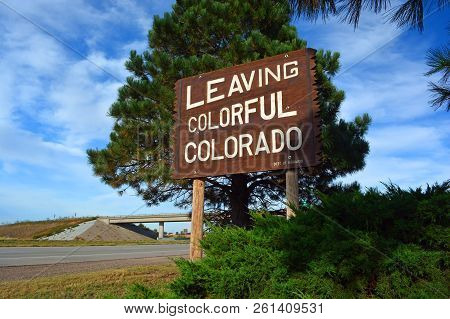 Large Leaving Colorful Colorado Wooden Roadside Highway Sign On A Sunny Day