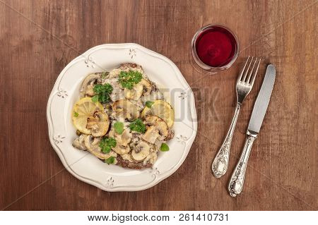 Overhead Photo Of Scallopine Di Vitello, Veal Scallopini, With Mushroom Sauce, Lemons, And Parsley, 