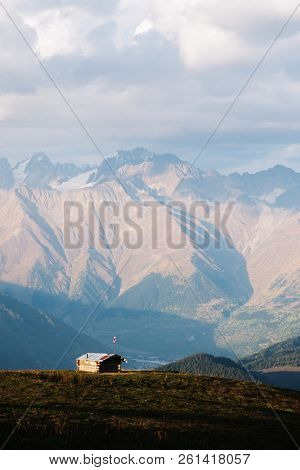 Caucasus Mountains in Samegrelo-zemo Svaneti, Georgia. Mountain hut and tourist lodges. Autumn evening landscape with ridge in clouds