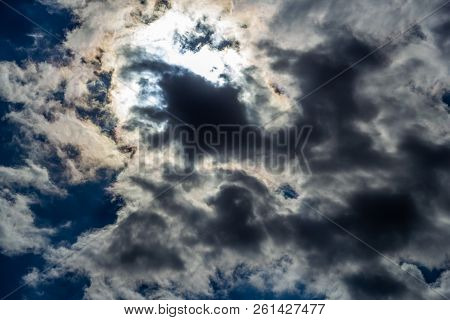 The Sun In The Sky Behind Dense Clouds