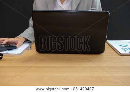 Financial Adviser Working With Calculator, Business Document & Computer At Office. Accountant Doing 