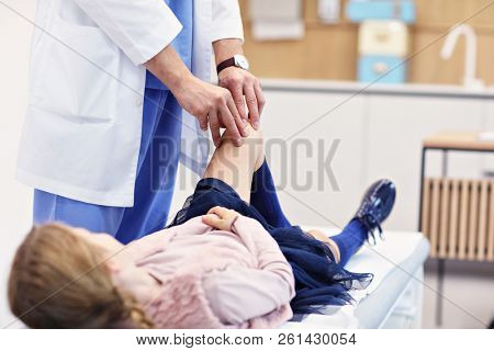 Little girl in clinic having a checkup with orthopaedist