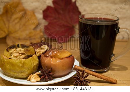 Hot Mulled Wine And Baked Apples With Spices, Walnuts, Cinnamon Sticka, Cloves And Anise Stars, Autu