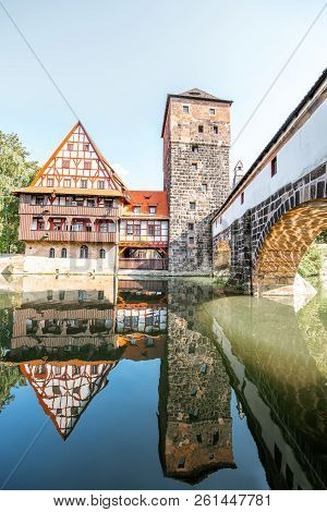 Beautiful Landscape View On The Riverside With Old Tower And House With Reflection In Nurnberg Durin