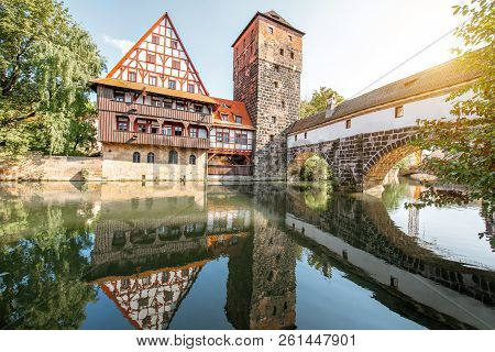 Beautiful Landscape View On The Riverside With Old Tower And House With Reflection In Nurnberg Durin