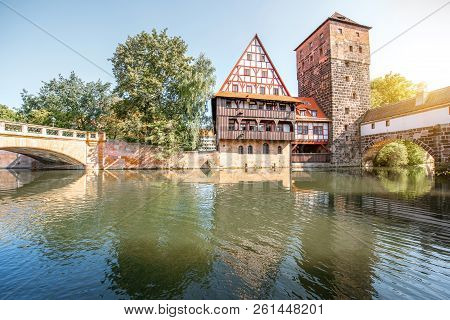 Beautiful Landscape View On The Riverside With Old Tower And House With Reflection In Nurnberg Durin
