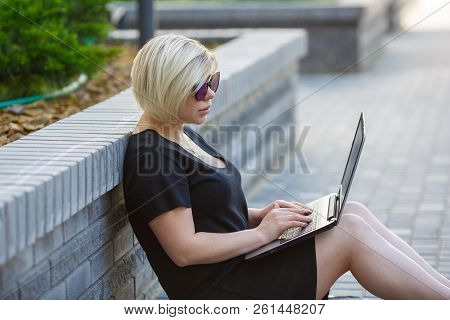 Woman Plus Size Walking Outdoors With Laptop In Sunglasses, Haircut Is Creative. Freelancer Works, L