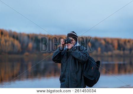 Porttrait Of Amateur Photographer Shooting The Autumn Scenery Of The River. Landscape Therapy