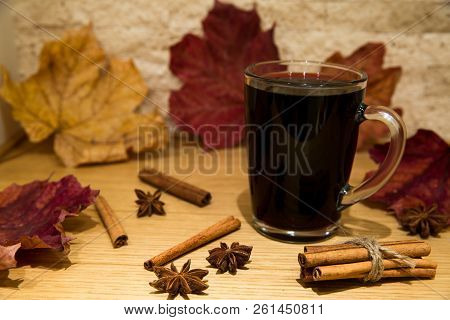 Red Mulled Wine With Spices: Cinnamon And Anise Stars, Autumn (fall) Leaves Background.