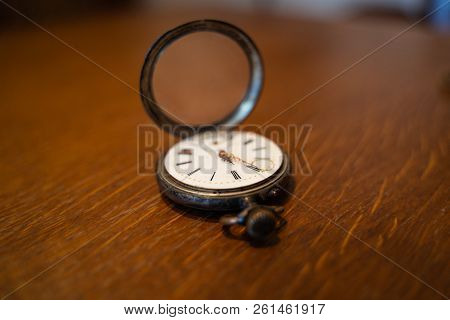 Old Pocket Watch Lies On A Table