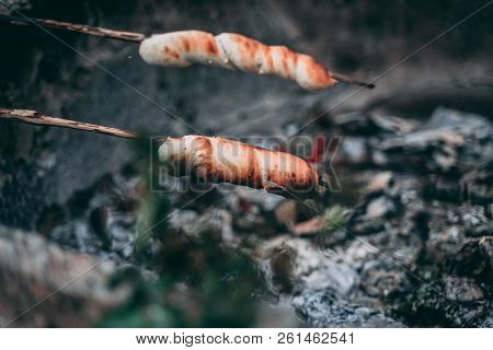 Stick Bread On A Wooden Skewer Over Fire