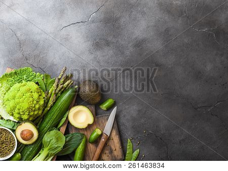 Assorted Green Toned Raw Organic Vegetables In Wooden Box On Dark Stone Background. Avocado, Cabbage