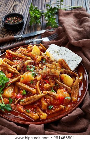 Greek Okra Tomato Stew With Potato Served With Feta Cheese Slices On A Earthenware Plate On A Rustic