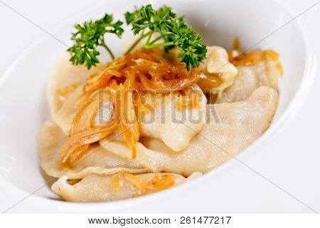 Dumplings Filled With Potato And Topped With Fried Onion On White Plate. Varenyky, Vareniki, Pierogi