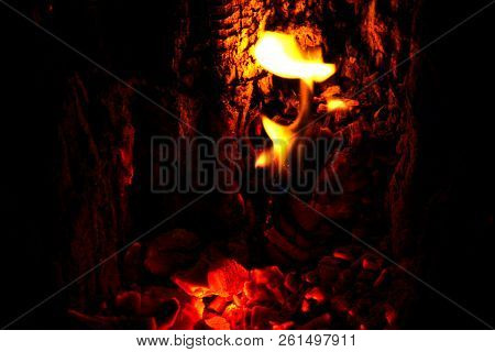 Fire Getting Darker As All The Wood Is Burned To Ashes. Closeup Photo Of Inside The Fireplace.