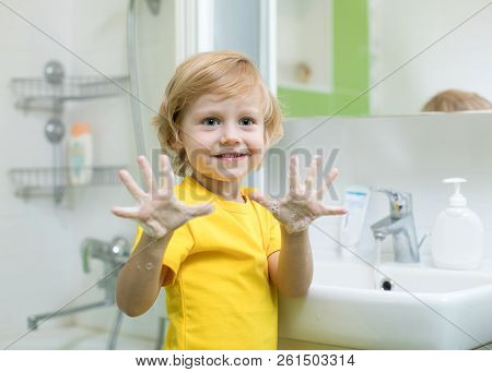 Cheerful Kid Washing Hands And Showing Soapy Palms
