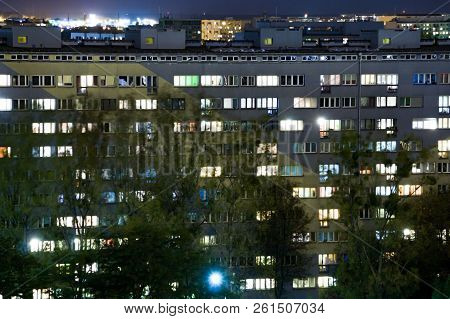 Windows Of Apartment Buildings At Night, The Light From The Windows Of Houses, The Evening Landscape