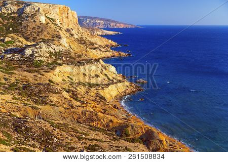 Beautiful Seascape. Red Beach On The Island Of Crete. A Mountain Range Stretches Along The Libyan Se
