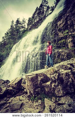 Tourist Woman At Svandalsfossen In Norway, Powerful Waterfall In Norwegian Mountains. National Touri