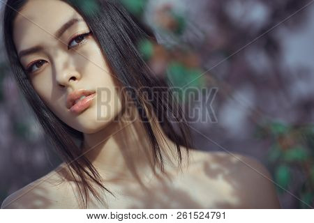 Sensual Young Woman Portrait At Blossoming Tree In The Garden. Beauty Of Woman And Nature Consept. C