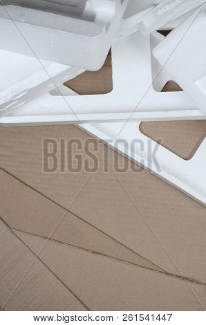 Background Image With Beige Cardboard Paper And Styrofoam Boxes Disgarded As Rubbish. The Concept Of
