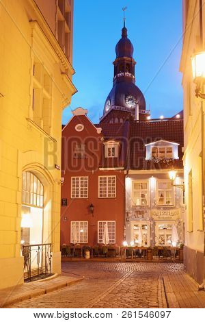 RIGA, LATVIA - SEPTEMBER 22, 2018: Night view to Kramu iela and Riga Cathedral. This street of old town is known from 1343
