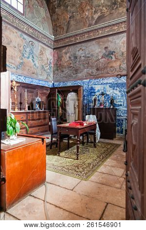 Santarem, Portugal - September 11, 2017: Baroque sacristy with blue tiles and frescos painted in the walls and ceiling. Church of Santa Cruz. 13th century Gothic Architecture 