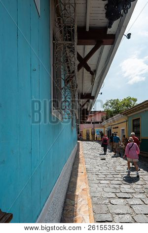 Guayaquil, Ecuador -- April 15, 2018. A Wide Angle Vertical Shot Of Tourists Walking Along A Side St