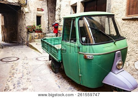 Tende, France - September 4, 2014:  Old Green Pickup Truck, Parked On Street  In Tende, Medieval Tow