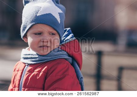 The Little Child Is Crying And Is Naughty In The Street