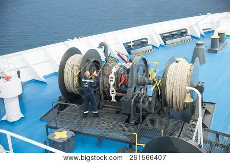 Aegean Sea, Greece/ July 17, 2018: Seaman Working On Foredeck Of Ferry Boat