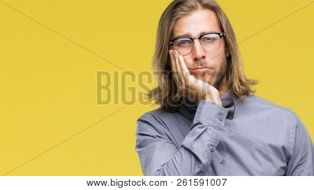 Young handsome man with long hair wearing bow tie over isolated background thinking looking tired and bored with depression problems with crossed arms.