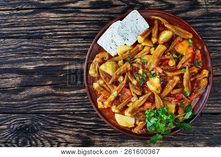 Okra Mpamies Giaxni Stewed With Tomatoes And Potatoes , Served With Feta Cheese Slices On A Earthenw