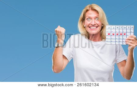 Middle age blonde woman holding menstruation calendar ver isolated background screaming proud and celebrating victory and success very excited, cheering emotion