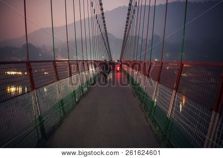 People Crossing Laxman Jhula Suspension Bridge On River Ganga
