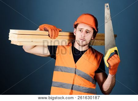 Carpenter, Woodworker, Labourer, Builder On Thoughtful Face Carries Wooden Beams On Shoulder. Woodcr