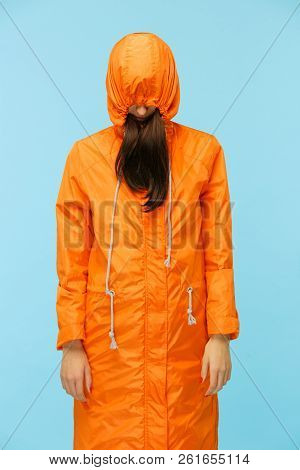 The Young Girl Posing At Studio In Autumn Jacket Isolated On Blue. Human Negative Emotions. Concept 
