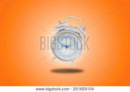 Alarm Clock, In Orange Background, That Sounds Madly With Hands That Turn Non-stop