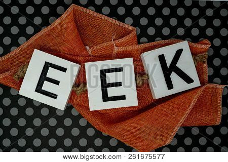 Eek Halloween Phrase Letters On Orange Fabric With Fun Black Polka Dot Background. Useful For Hallow