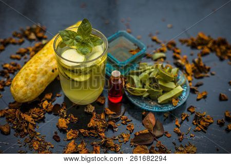 Close Up Of Organic Face Pack Of Cucumber With Aloe Vera Gel And Rose Oil On Wooden Surface In A Gla