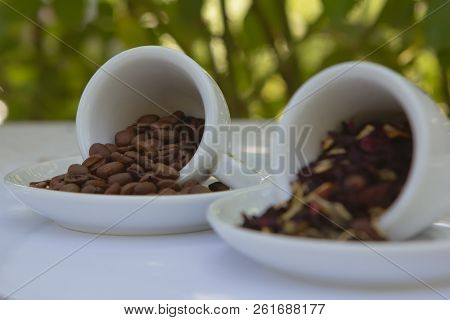 Bright Colorful Background With Ceramic White Cups Of Coffee Beans And Tea Petals