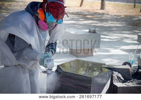 Processing Of Wild Stone Gabbro Granite With An Angle Grinder, The Sculptor Creates A Masterpiece.