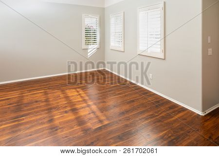 Newly Installed Brown Laminate Flooring and Baseboards in Home.